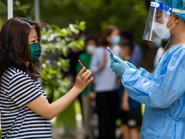 A health worker registers a local resident for a test for the Covid-19 coronavirus in Pudong district of Shanghai. Picture: LIu Jin / AFP