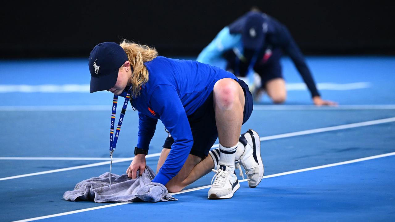 Ballkids wiped the court three times before play was able to resume for a second time. Picture: Quinn Rooney/Getty Images