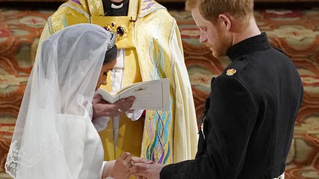 Meghan and Harry exchange rings. Credit: AFP Photo/Pool/Owen Humphreys