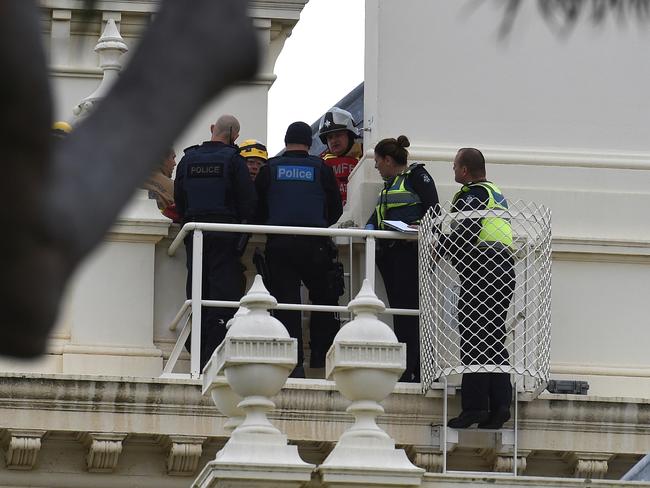 Emergency services on the roof with the man. Picture: Nicole Garmston