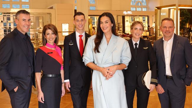 Qantas Loyalty boss Andrew Glance (R), David Jones brand ambassador Megan Gale (C), and David Jones boss Scott Fyfe (L) with staff for the loyalty scheme announcement. Picture: Supplied / David Jones