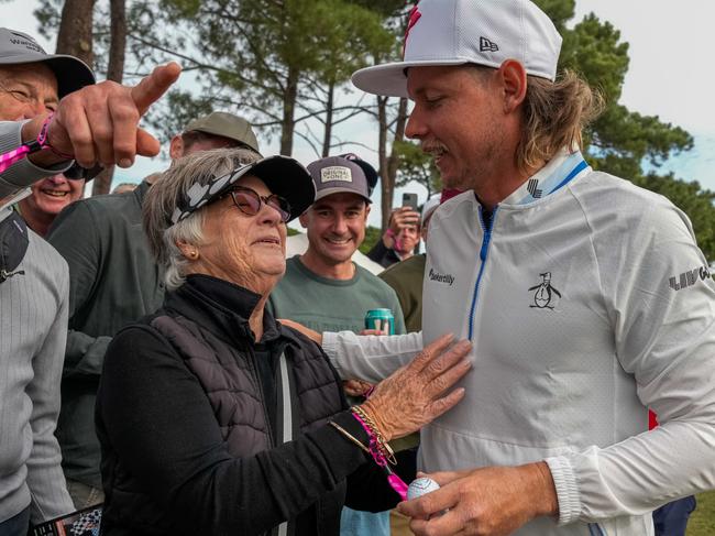 ADELAIDE, AUSTRALIA - APRIL 27: Cam Smith of Ripper GC (Right) gives spectator Annette Blake (Left) a signed ball after his wayward tee shot on the 17th hole, hit the spectator on the back and bounced back onto the fairway during LIV Adelaide at The Grange Golf Club on April 27, 2024 in Adelaide, Australia. (Photo by Asanka Ratnayake/Getty Images)