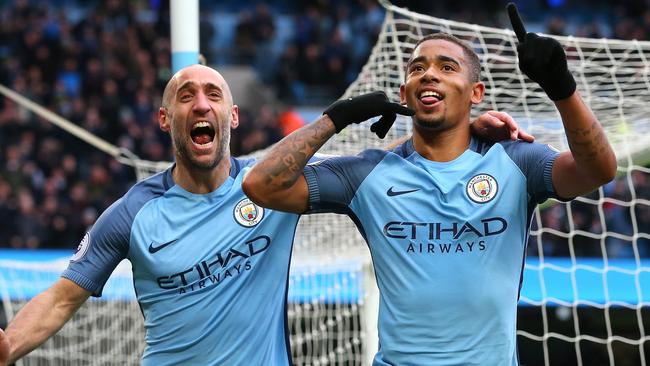 Gabriel Jesus of Manchester City (R) celebrates scoring.