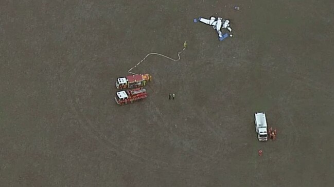 Emergency services near the spot where one of the two planes crashed after the mid-air collision. Picture: 7 News