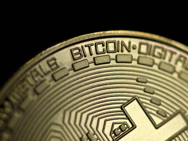 (FILES) In this file photo taken on January 26, 2020 The photo shows a physical imitation of a Bitcoin in Dortmund, western Germany. - Bitcoin has enjoyed a record-breaking week after electric carmaker Tesla and Wall Street finance giants sparked a goldrush for the world's most popular virtual currency, but bubble fears persist. The cryptocurrency topped $52,000 on March 17, 2021 after investment fund giant BlackRock also confirmed a push into the booming sector. (Photo by INA FASSBENDER / AFP)