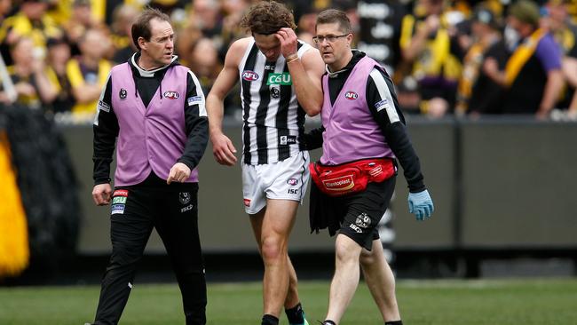 Magpie Matt Scharenberg is helped off the ground after rupturing his ACL against Richmond. Picture: Darrian Traynor/AFL Media/Getty Images