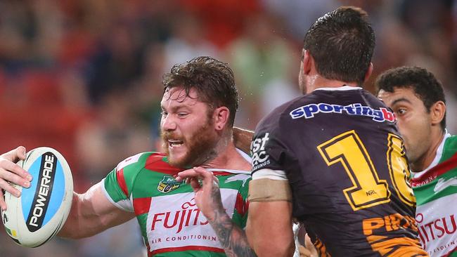 Rabbitoh Chris McQueen is tackled by Bronco Matt Gillett in Round 1.