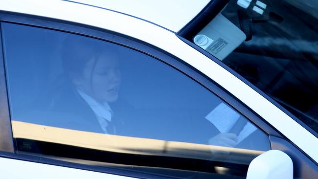 Reading material on this driver’s steering wheel on Manly Rd. Picture: John Grainger