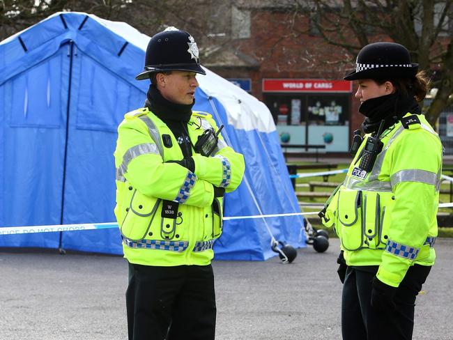 British police officers stand on duty at a cordon near a bench covered in a protective tent (R), at The Maltings shopping centre in Salisbury, southern England, where the Skirpals were poisoned. Picture: AFP