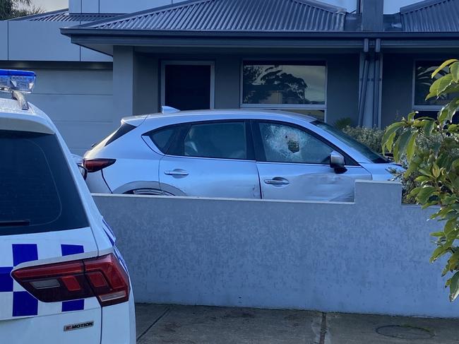 The man crashed into the police van, two other parked cars and a fence in a panicked attempt to escape the scene. Picture: Owen Leonard