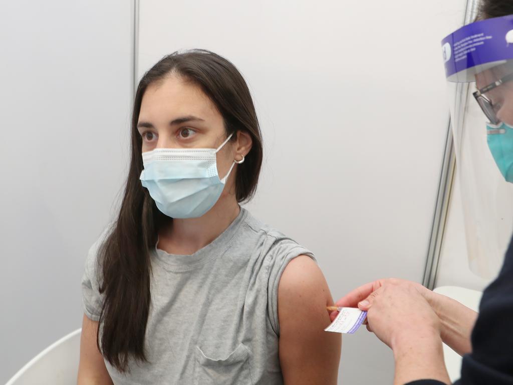 A Melbourne woman gets her Pfizer jab at a vaccination centre in St Kilda. Picture: David Crosling