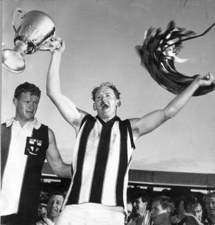 18: DARREL BALDOCK. Baldock holds St Kilda's first ever VFL Premiership Cup after captaining the side in the Grand Final. Known as 