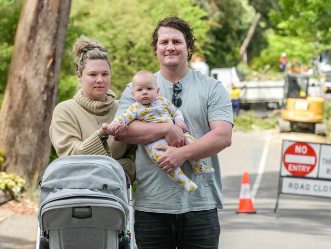 ADELAIDE, AUSTRALIA - NewsWire Photos NOVEMBER 18, 2022: Kyra Middlemiss and her husband Daniel O'Rielly and baby Charlie are amongst of hundreds of residents of Stirling in the Adelaide Hills who are recovering from a devastating storm last Saturday. The Mabel St residents are still without power seven days later. Picture: NCA NewsWire / Brenton Edwards