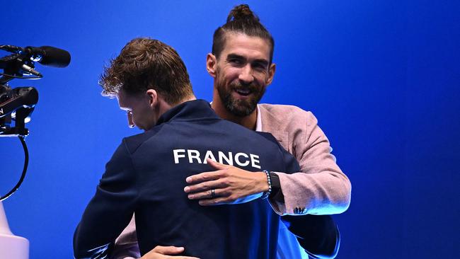 Phelps hands the individual medley baton to his heir apparent. (Photo by Quinn Rooney/Getty Images)