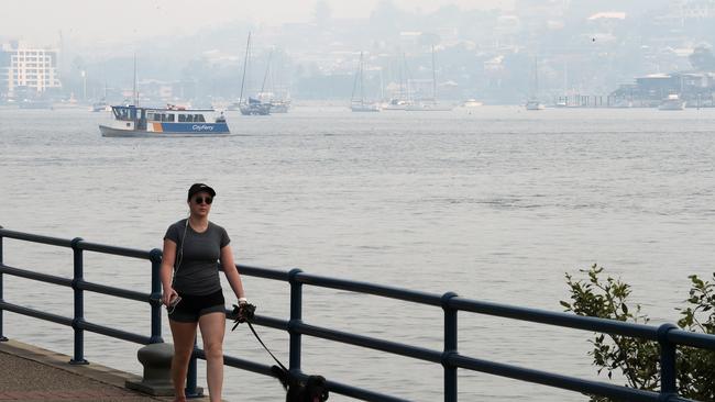 Smoke conceals the Brisbane skyline. Picture: Liam Kidston.