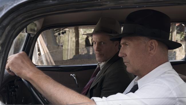 This image released by Netflix shows Woody Harrelson, left, and Kevin Costner in a scene from 