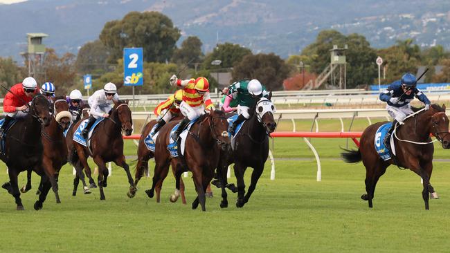 Vibrant Sun (right) kicks clear to win the 2024 Australasian Oaks. Picture: Russell Millard