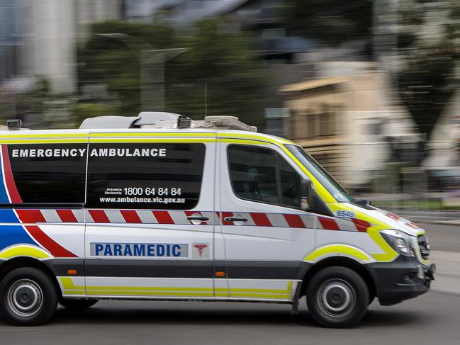 MELBOURNE, AUSTRALIA - NewsWire Photos FEBRUARY 13, 2022: An ambulance speeds away from the Royal Melbourne Hospital. Ambulance, Generic.Picture: NCA NewsWire / David Geraghty