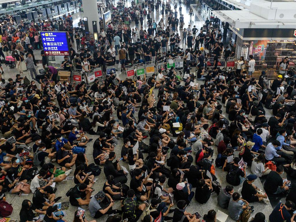 Hong Kong pro-democracy protesters (bottom) block access to the departure gates. Picture: Philip Fong/AFP