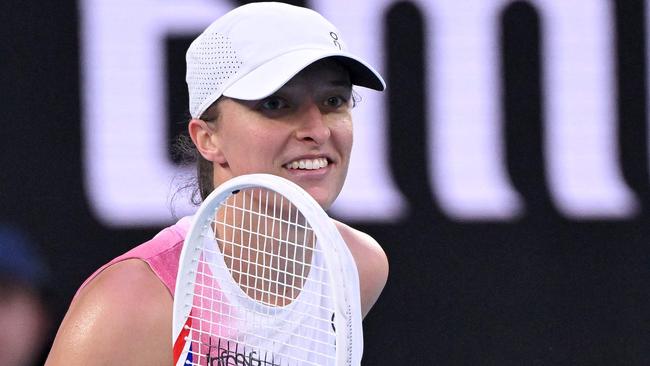 Poland's Iga Swiatek reacts on a match point against Germany's Eva Lys during their women's singles match on day nine of the Australian Open tennis tournament in Melbourne on January 20, 2025. (Photo by WILLIAM WEST / AFP) / -- IMAGE RESTRICTED TO EDITORIAL USE - STRICTLY NO COMMERCIAL USE --