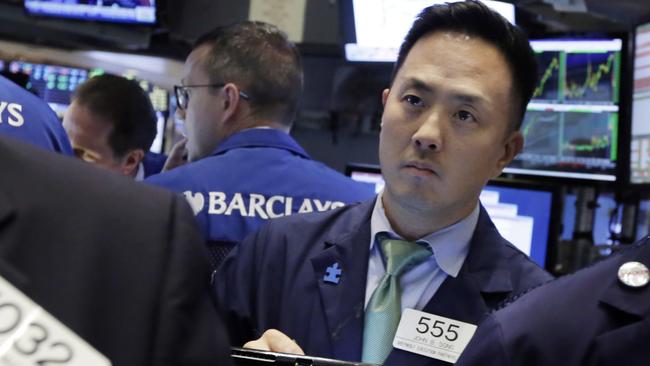 Trader John Song works on the floor of the New York Stock Exchange, Thursday, Aug. 13, 2015. Global stocks are steadying as the decline in China's currency slowed and the country's central bank tried to ease fears of more big declines. (AP Photo/Richard Drew)