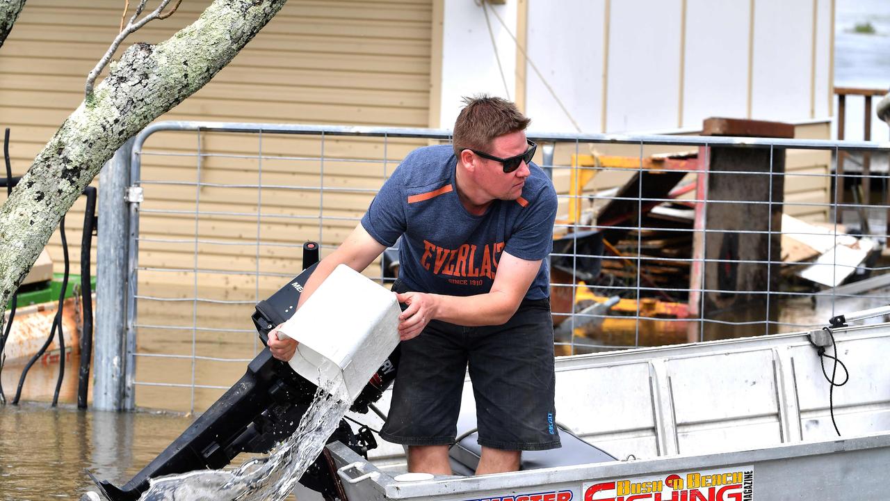 A man removes water from his boat before visiting a flood affected neighbourhood in Lawrence, 70 km from the New South Wales town of Lismore, on March 1, 2022. Picture: SAEED KHAN / AFP