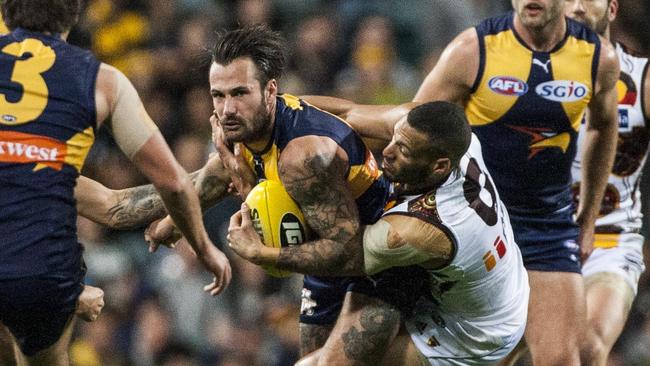 Josh Gibson wraps up Chris Masten in a tackle. Picture: AAP