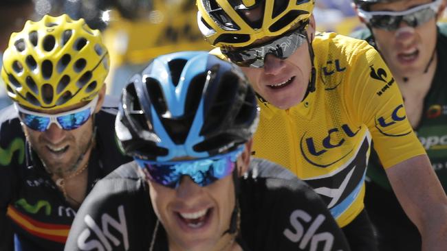 Richie Porte, front, puts in a powerhouse effort for teammate Chris Froome (in yellow jersey), in the 20th stage of the Tour de France. Picture: Laurent Cipriani (AP)