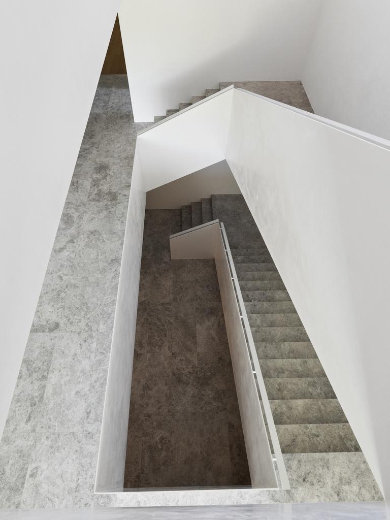 The staircase was crafted from polished plaster, steel and Tundra marble.