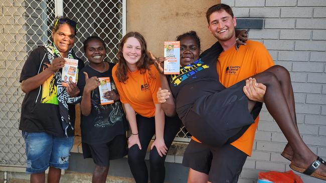 Interstate volunteers Emma and Angus (orange shirts) doorknocking for the CLP.