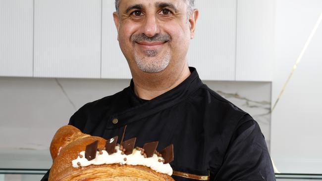 La Doree cafe owner and pastry chef Khaled Khanji with the croissant that takes him three days to make. Picture: Jonathan Ng