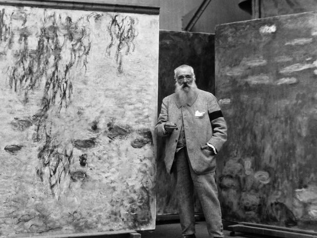 Claude Monet with some of his giant water lily canvases.