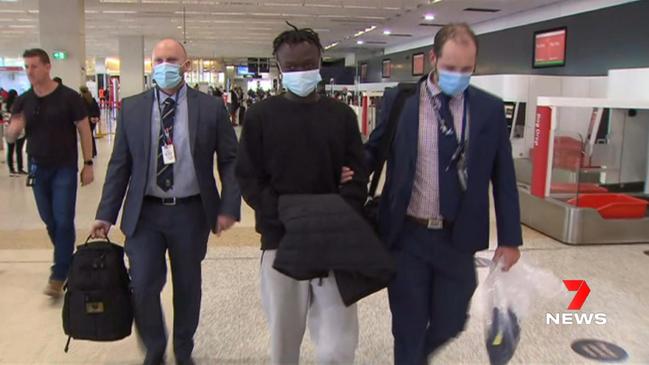 Mathiang Malok as he was taken through Melbourne Airport in 2022 as he was returned to Adelaide by SA Police Operation Meld officers. Picture: 7NEWS