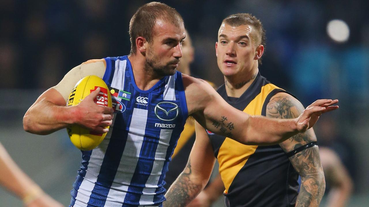 Flashback – Ben Cunnington of the Kangaroos prepares to fend off with the ball infront of Dustin Martin of the Tigers during the round 11 AFL match between the North Melbourne Kangaroos and the Richmond Tigers at Blundstone Arena on June 3, 2016 in Hobart, Australia. (Photo by Michael Dodge/Getty Images)