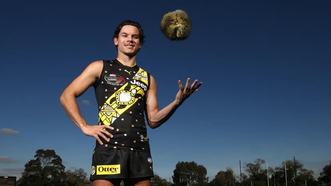 Richmond star Daniel Rioli, wearing the Indigenous Round Dreamtime jumper he designed with his parents in the Tiwi Islands, ready to play in the Dreamtime Game at Darwin’s TIO Stadium last year. He holds a local Indigenous football called a Marngrook (meaning game ball) with links to the AFL game. Picture: David Caird