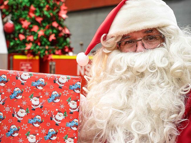 FAIRFIELD ADVANCE/AAP.. Santa getting ready at Horsley Park Rural Fire Station in Horsley Park on Friday 5 December 2019. Horsley Park hosts Christmas carols every year from 4pm to 10pm at the reserve. The money raised goes to local community initiatives - this year it's going to the Horsley Park Rural Fire Brigade.  (AAP IMAGE / Carmela Roche)