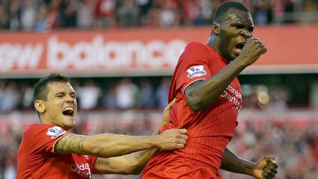 Liverpool's Christian Benteke right, celebrates with team-mate Dejan Lovren after he scores the first goal for his side during their English Premier League soccer match against Bournemouth at Anfield in Liverpool, England, Monday Aug. 17, 2015. (AP Photo/Clint Hughes)