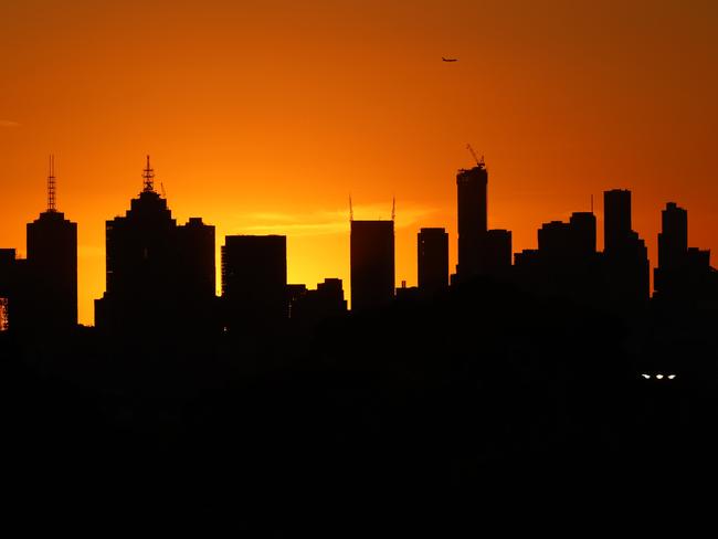 Sunset over Melbourne from Camberwell, as plane flies over the city. .  Picture: Alex Coppel.