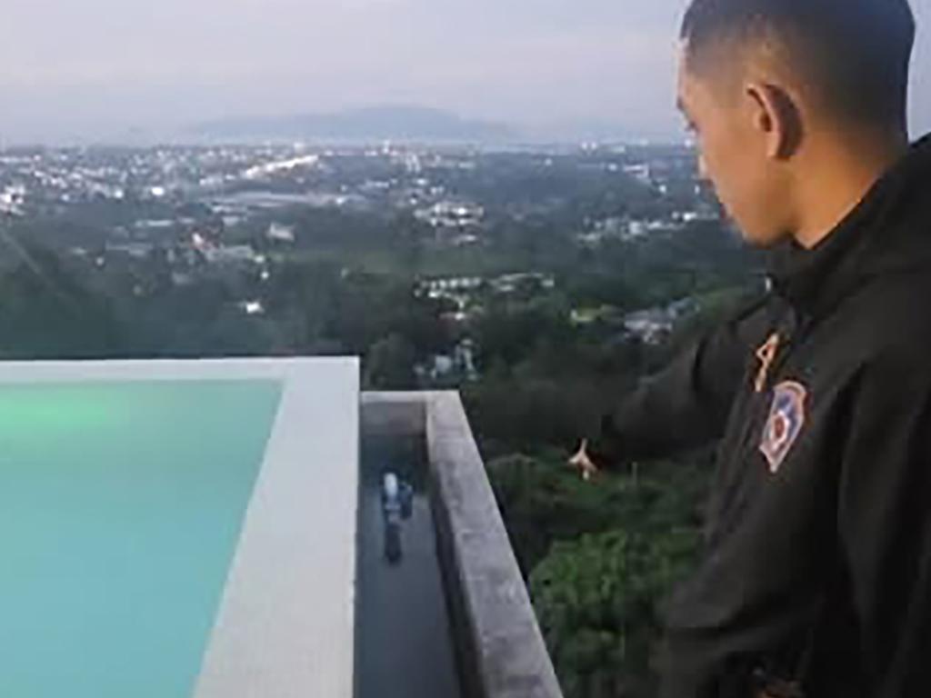 The acrobat fell about 15 metres from the apparently unguarded rooftop pool down into a gulley. Picture: East 2 West News
