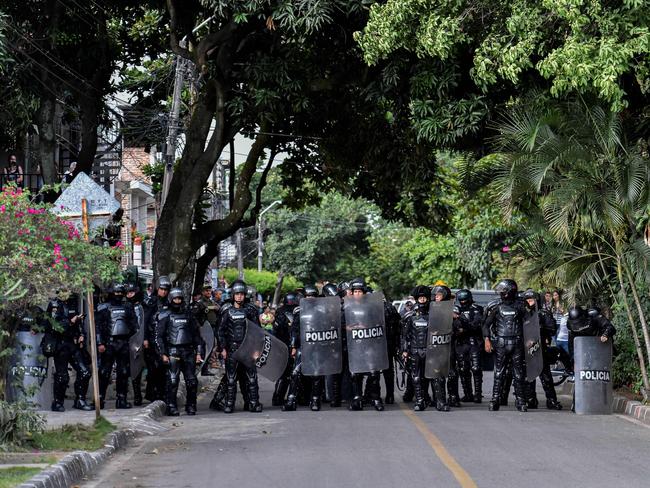 Riot police stand guard outside the community hall of the Aguablanca neighbourhood, in Cali, Colombia. Picture: AFP