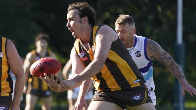 Patrick Molony dishes off the handball for Heidelberg West. Picture: Valeriu Campan