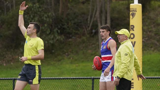 EFNL: Umpires discuss a review in Rowville v South Croydon. Picture: Valeriu Campan