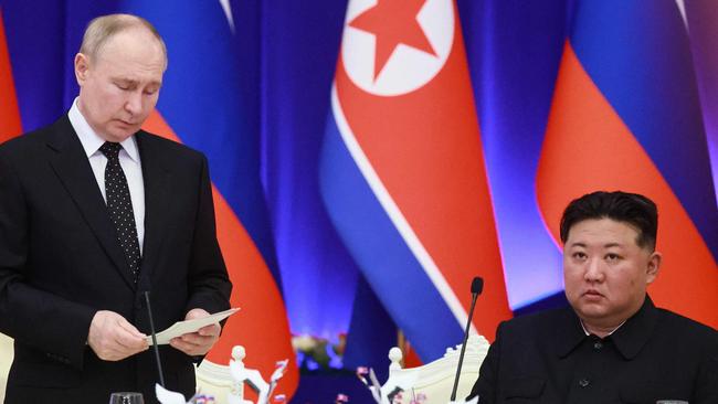 TOPSHOT - In this pool photograph distributed by the Russian state agency Sputnik, Russian President Vladimir Putin (L) speaks as North Korean leader Kim Jong Un listen during a reception at the Mongnangwan Reception House in Pyongyang on June 19, 2024. Putin enjoyed a red carpet welcome, a military ceremony and an embrace from North Korea's Kim Jong Un during a state visit to Pyongyang where they both pledged to forge closer ties. (Photo by Vladimir Smirnov / POOL / AFP) / -- Editor's note : this image is distributed by the Russian state owned agency Sputnik --