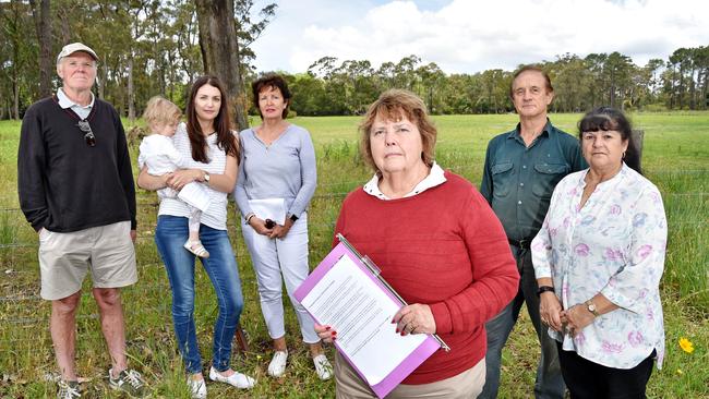 Somersby residents (l-r) Wal Shepherd, Sarah Hinde &amp; daughter Liliana, 1, Janette Cox, Wihelmina Hunt, Bob Hunt, &amp; Therese Pisani are hopeful the submission won’t pass. Picture: AAP IMAGE / Troy Snook