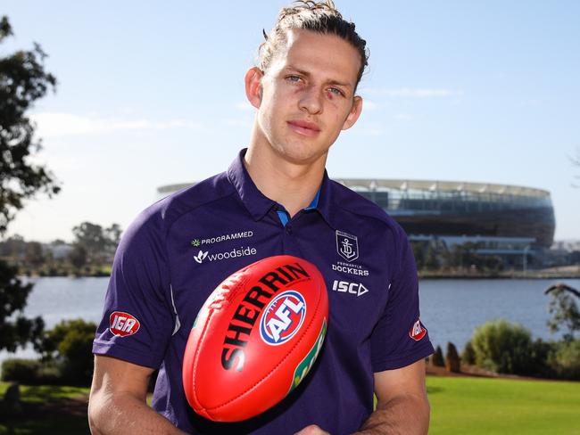 Fremantle Dockers captain Nat Fyfe poses for a photograph opposite the new Perth Stadium in East Perth on Monday, July 17, 2017. Nat Fyfe has signed a six year contract with the Fremantle Dockers. (AAP Image/Richard Wainwright) NO ARCHIVING