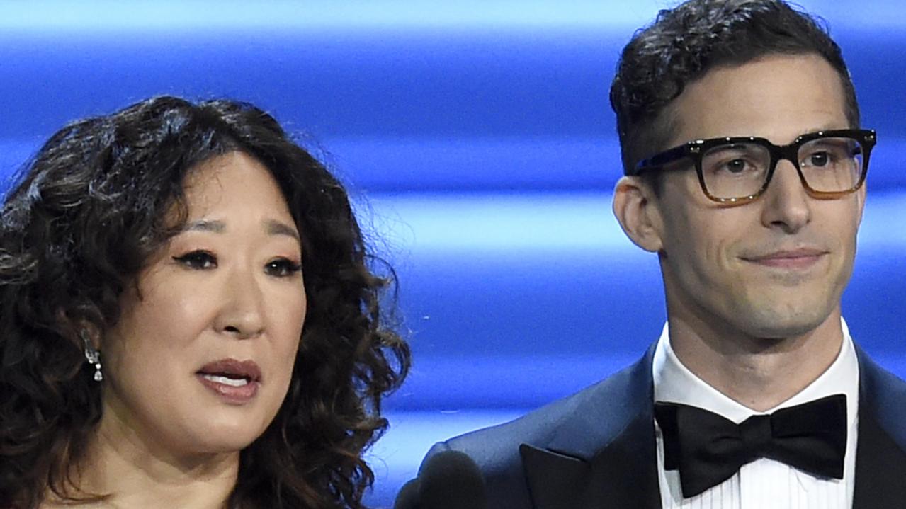 FILE - In this Sept. 17, 2018 file photo, Sandra Oh, left, and Andy Samberg present an award at the 70th Primetime Emmy Awards in Los Angeles. Oh and Samberg will share host duties at next monthâ€™s Golden Globe ceremony.  (Photo by Chris Pizzello/Invision/AP, File)