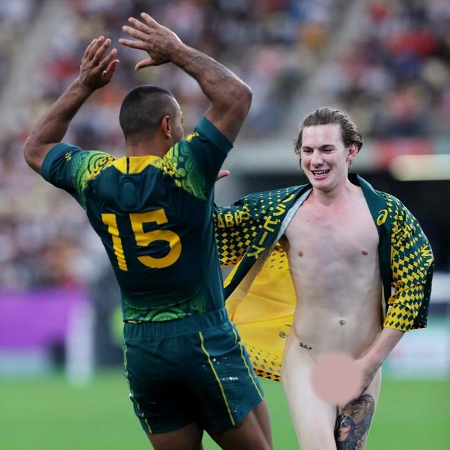 Kurtley Beale of Australia reacts to a streaker during the Rugby World Cup 2019 Group D game between Australia and Uruguay at Oita Stadium on October 05, 2019 in Oita, Japan. (Photo by Shaun Botterill/Getty Images)