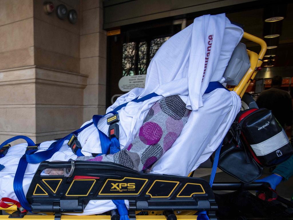 Raelene Polymiadis is taken out of court on stretcher after collapsing in the court cells before an appearance. Picture: NCA NewsWIRE / Emma Brasier