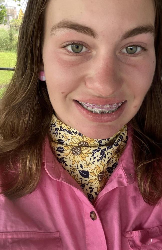 Payton Rozynski wears a neck scarf she handmade for her business, The Creative Cow