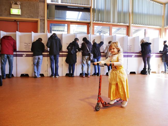 Amelie Richards 4 rides her scooter dressed as aprincess while mum votes at the Freshwater Poling Booth in Sydney on election day. Picture: Braden Fastier